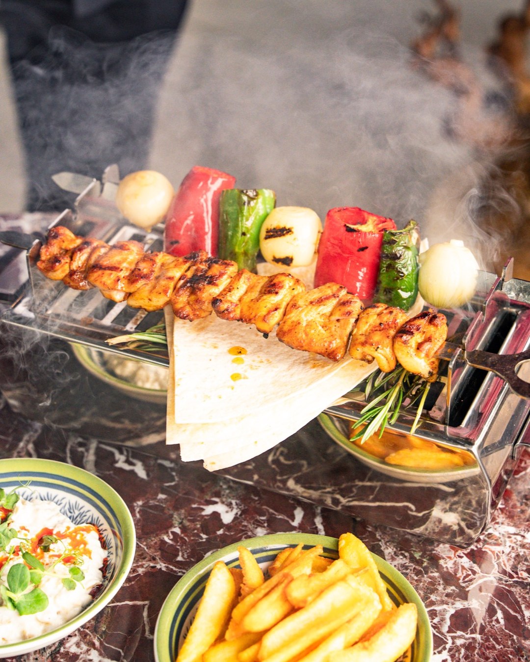Grilled Meat by the Bosphorus: The Grill Menu at Loi Bosphorus 5 Loi Bosphorus - chicken skewers cooking on the grill with roasted peppers and tomatoes